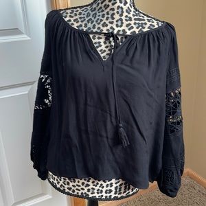 Cute loose fitting rayon top with crochet look cut outs on sleeve. Worn once